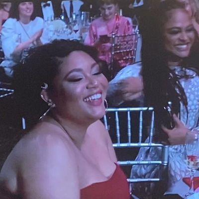 Ciara is wearing a sleeveless red dress.